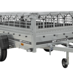 Einachsiger Anhänger auf Blattfedern 264×125 UNITRAILER GARDEN 264/R KIPP mit Gitterseitenwänden, H-0-Rahmen und grauer Plane
